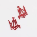 Macro detail of red matte origami crane pendants with top rings for DIY jewelry making - Red