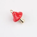 Detailed macro view of red enamel mushroom pendant with golden dots for DIY jewelry - Red