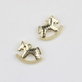 Detailed close-up of golden rocking horse charms with hammered texture for DIY jewelry making - Gold