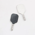 Macro detail of pickleball paddle charms featuring black enamel and honeycomb texture - Silver Edge Black