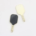 Macro shot of two golden pickleball racket pendants with honeycomb texture and black enamel - Black with Gold Edge