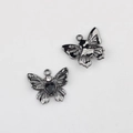 Vue macro du pendentif papillon avec pierre en cœur noire et détails en strass - Base Noir Fusil Zircone Noire