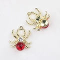 Detail view of spider charms with gold plating, red resin body and clear zircon accent - Gold Red