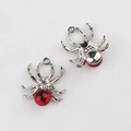 Detailed view of spider pendant charm with red resin bead and clear zircon inlay - Silver Red