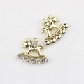 Macro detail of golden rocking horse charms with sparkling zircons for jewelry making - Gold / White Zirconia