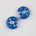 Macro shot of blue cookie-shaped acrylic beads with M letter for DIY jewelry making - Sapphire Blue