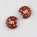Macro detail of brown chocolate cookie charms with colorful m-letter candy dots - Brown