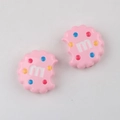Close-up of pink bitten-cookie acrylic charms with colorful dots and letter m pattern - Pink