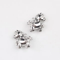 Macro shot of silver alloy pony charms for DIY jewelry making on white background - Silver