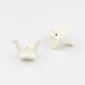 Close-up of white paper crane charms with a smooth finish for DIY jewelry making - White