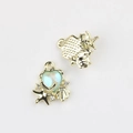 Macro detail of ocean-style heart pendant with opal stone and golden starfish charms - Gold Base Blue