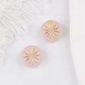 Vue macro de perles en verre rose avec motif de tournesol doré pour bijoux DIY - Rose