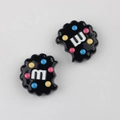 Detail of black acrylic cookie beads with m-letter and colorful dots for DIY crafts - Black