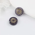 Nahaufnahme violetter tschechischer Glasperlen mit goldener Blumengravur für DIY Schmuck - Transparent Violett