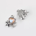 Detailed view of silver heart pendant with starfish shell accents and pink iridescent inlay - Silver Yellow