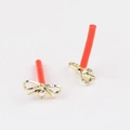 Detailed view of gold bow-knot stud earrings with protective needle covers on a white surface - Gold