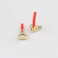 Detail of gold heart charms showing smooth front and textured back for jewelry making - Gold