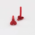 Macro shot of red heart earring studs with matte finish and wavy textured edges - Red