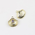 Macro detail of shell-shaped pendants with purple gemstone and starfish relief for DIY jewelry - Gold Purple Zirconia