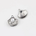 Detailed view of silver shell pendants with pearls and star motifs for jewelry making - Silver Pearl