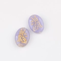 Macro detail of oval lavender glass beads with gold painted Chinese motifs for DIY crafts - Purple (00851001)