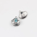 Macro detail of silver scallop shell pendant with blue rhinestone inlay for DIY jewelry - Silver/Blue Zirconia
