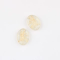 Close-up of Czech glass beads featuring gold gilded cat pattern for DIY jewelry crafts - Clear (00851201)