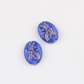 Macro detail of oval blue glass beads with gold-painted ancient Egyptian cat motifs - Transparent Blue (00851601)