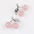 Close-up of pink glitter resin cherry pendants with silver leaves for DIY jewelry - Silver Branch & Pink Cherry