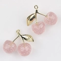 Detail view of cherry charms with pink glitter resin and golden metal loops for jewelry DIY - Gold Branch & Pink Cherry