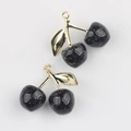 Detailed macro view of black glitter cherry pendants with gold leaves for DIY jewelry - Gold Branch & Black Cherry