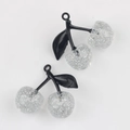 Close-up of DIY cherry charms with silver glitter resin fruit and black leaves detail - Black Branch & White Cherry