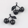 Macro detail of cherry charms with black finish and glitter for DIY jewelry making - Black Branch & Black Cherry