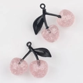 Close-up of pink glitter cherry charms with black leaves for DIY jewelry making - Black Branch & Pink Cherry