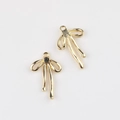 Detailed view of gold bow charms with zircon inlay and hanging loops for DIY jewelry - Gold Black Zirconia