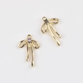 Detail of gold bow pendants with purple zircon inlays for DIY jewelry making - Gold Purple Zirconia