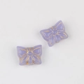 Close-up of vintage purple glass butterfly beads with gold edges for DIY jewelry making - Purple