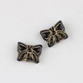Close-up of vintage butterfly beads with black glaze and gold-painted details - Black