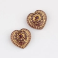 Detail of heart-shaped Czech glass beads with gold floral engraving for DIY jewelry - Transparent Brown