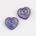 Detail of heart-shaped blue glass beads with gold floral patterns for DIY jewelry - Blue