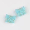 Macro detail of blue glass butterfly beads with vintage gold rim for DIY jewelry - Sky Blue