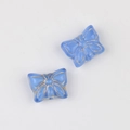 Macro detail of sky blue butterfly beads with gold edges for DIY jewelry making - Sapphire Blue
