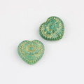 Detail of green heart-shaped glass beads with vintage gold floral engraving for DIY jewelry - Emerald Green