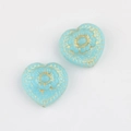 Detail of blue glass heart beads with gold floral carvings for DIY jewelry making - Lake Blue