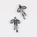 Gros plan de pendentifs nœuds noirs avec strass pour création de bijoux DIY - Base Noir Fusil Pierre Rose