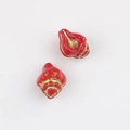 Detailed view of red and gold conch-shaped Czech glass beads for DIY jewelry making - Red