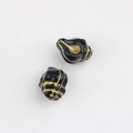 Macro detail of conch-shaped black glass beads with vintage gold foil texture lines - Black