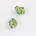 Detailed macro view of 11x13mm green Czech glass conch beads with gold painted accents - Transparent Green