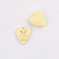 Macro shot of yellow heart charms with bear pattern and smooth surface for DIY jewelry - Yellow Heart