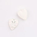 Macro shot of white heart charms with cute 3D bear relief for DIY jewelry accessories - White Heart